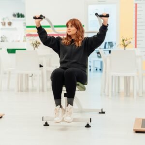 A woman exercises on gym equipment in a modern indoor setting in Yalova, Türkiye.