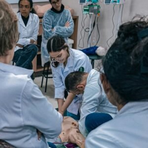 Group of medical students practicing on a dummy in a classroom setting in Brazil.